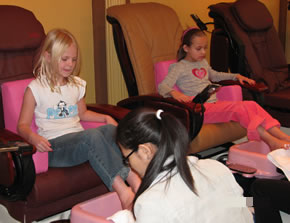 girls receiving spa foot pedicure treatment